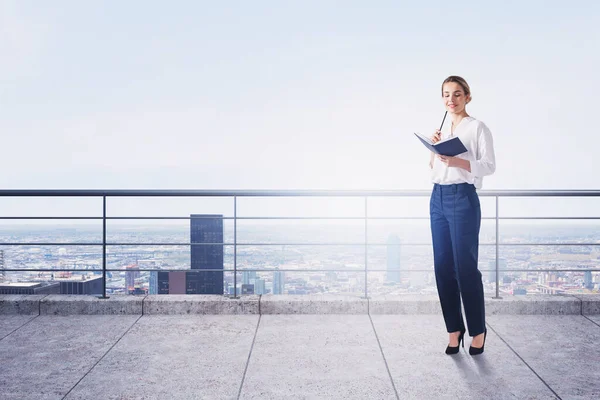 Young Businesswoman Standing Notebook Balcony Modern Cityscape Concept Management Toned — Stock Photo, Image