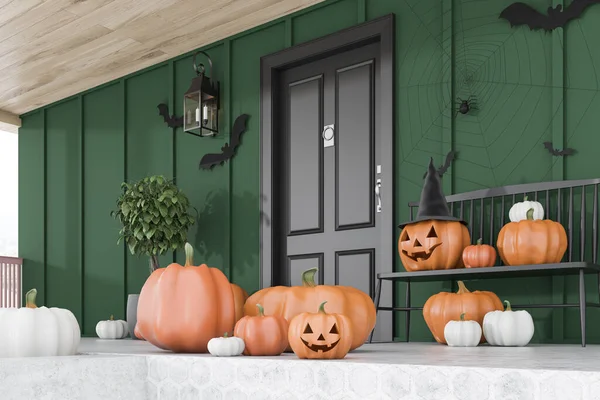 Carved pumpkins, bats and spiders on floor and bench near modern house with black front door, tree in pot and green walls. Side view. Concept of halloween. 3d rendering