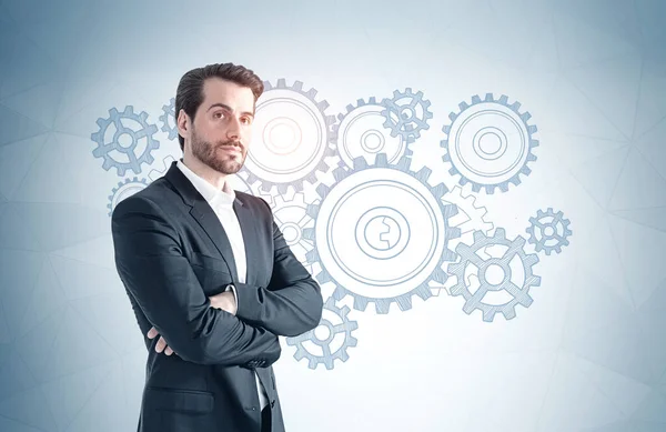 Portrait Confident Young Bearded Businessman Standing Bear Gray Wall Gears — Stock Photo, Image