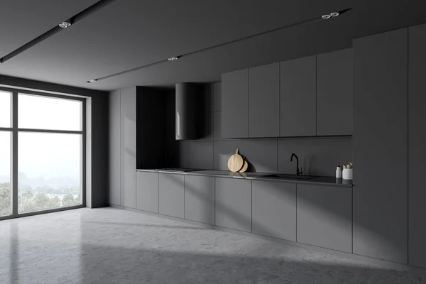Corner of stylish kitchen with gray walls, concrete floor and gray cabinets and cupboards. 3d rendering