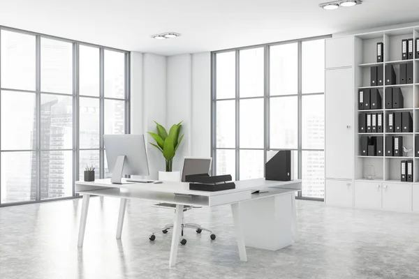 Corner of stylish CEO office with white walls, concrete floor, computer table and bookcase with folders. 3d rendering