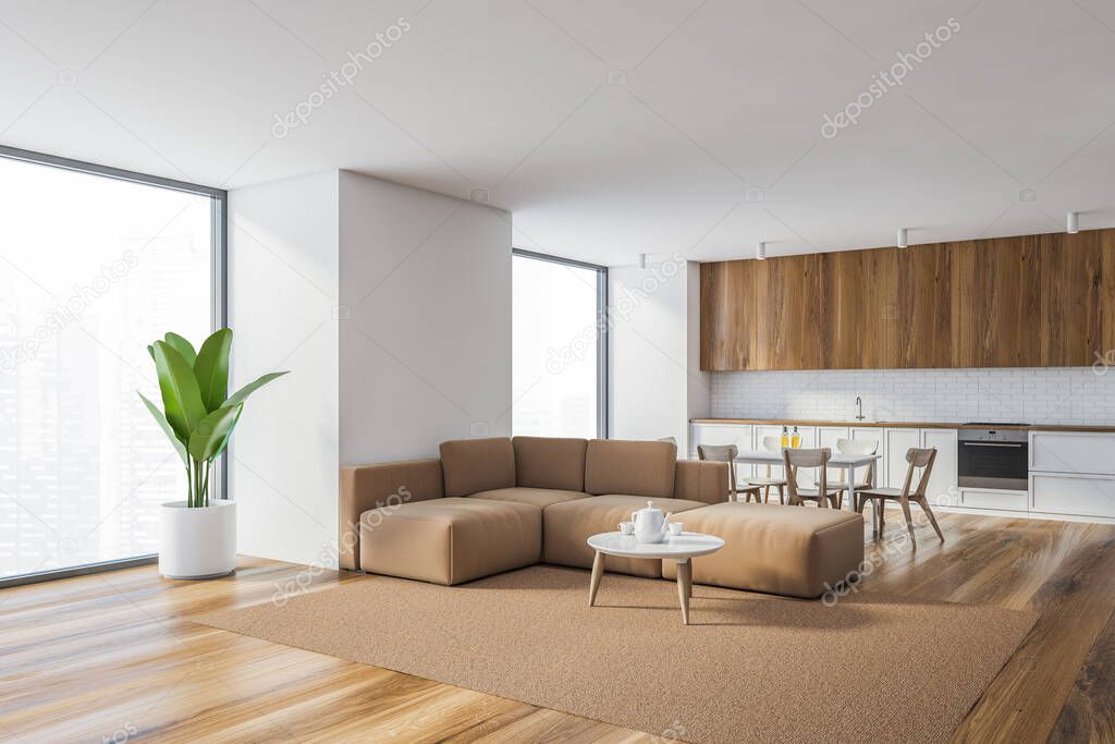 Corner of stylish living room with white walls, wooden floor, beige sofa and kitchen in background. 3d rendering