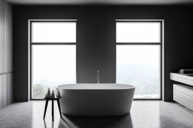 Gri ve ahşap duvarları, beton zemini, rahat küveti ve bulanık manzaralı pencereleri olan şık bir banyo. 3d oluşturma