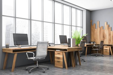 Gri ve ahşap duvarları, beton zemini ve ahşap bilgisayar masaları olan modern açık uzay ofisinin köşesi. 3d oluşturma