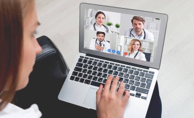 Tanımlanamayan genç bir kadının tıp doktorlarıyla görüntülü görüşmesi. Teknoloji ve teletıp kavramı