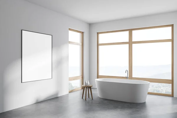 Corner of stylish bathroom with white walls, concrete floor, comfortable bathtub and three windows with blurry view. Vertical mock up poster on wall. 3d rendering