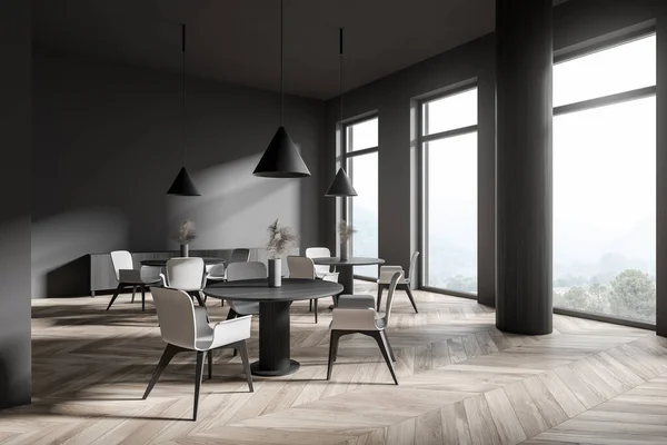 Corner of modern restaurant with dark gray walls, wooden floor, round dining tables with white chairs and gray sofa. 3d rendering