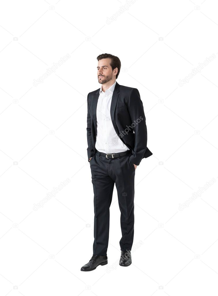 Isolated full length portrait of young businessman standing with hands in pockets. Concept of management