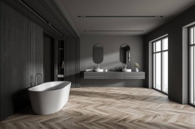 Gri ve ahşap duvarları olan modern banyonun içi, ahşap zemin, rahat küvet ve aynalı çift lavabo. 3d oluşturma
