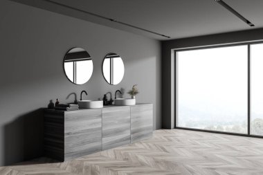 Gri duvarlı modern banyonun köşesi, ahşap zemin, çift lavabo ve iki yuvarlak ayna. Bulanık görüşlü bir pencere. 3d oluşturma