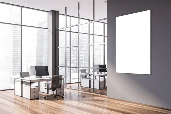 Mock up poster hanging in modern open space office corner with gray walls, wooden floor and rows of white computer tables. 3d rendering
