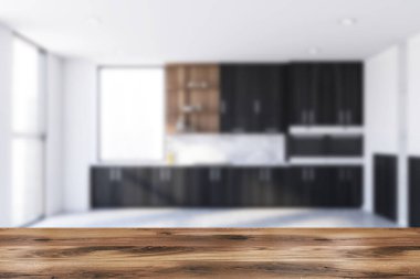 Ürününüz için ahşap masa bulanık mutfağında beyaz duvarlar, beton zemin ve lavabo ve fırında yapılmış siyah dolaplar. 3d oluşturma