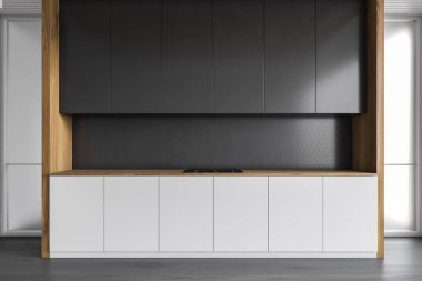 Gri duvarları, ahşap zemini, beyaz ve siyah dolapları olan şık bir mutfak. 3d oluşturma