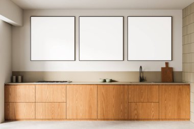 Ahşap dolaplar ve nötr tonların yer aldığı üç kare boş poster tasarımıyla çağdaş mutfak içi. 3B Hazırlama