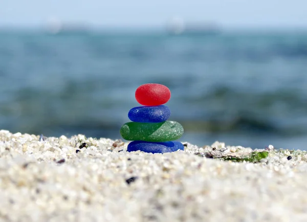 Zen sea glass stack sculpture near the sea. Harmony, balance and simplicity concept. Beach walk, beach seaglass cairn.