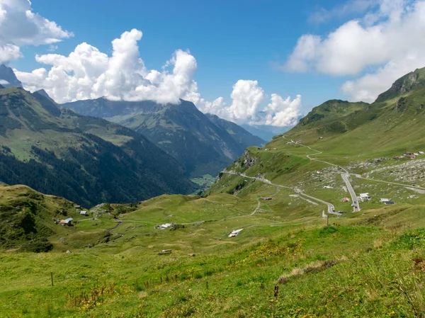 high mountain peaks covered in mystic fog on a scenic day in summer, Switzerland