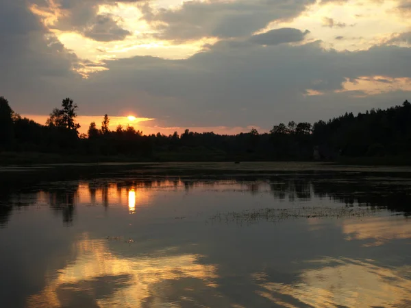 beautiful sun set on calm lake, red sun, calm lake, quiet evening, Latvia
