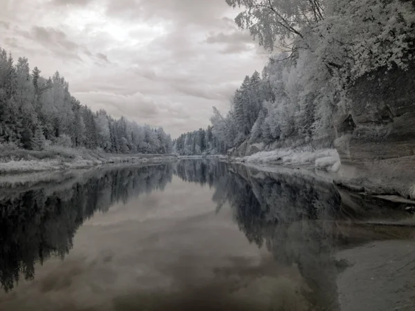 infrared photo of river view and Sietiniezis sandstone cliff, beautiful white trees and wooden footpaths, picture taken with specially adapted infrared camera, Latvia