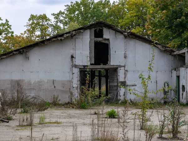 autumn landscape with demolition of the building, destroyed building, surrounded by colorful trees