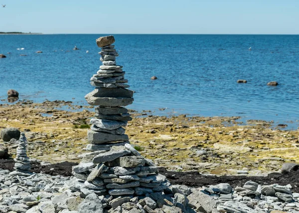picture with beautiful white stone piles by the sea, these objects were built by travelers, Saaremaa Island, Estonia