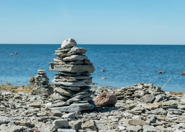 picture with beautiful white stone piles by the sea, these objects were built by travelers, Saaremaa Island, Estonia