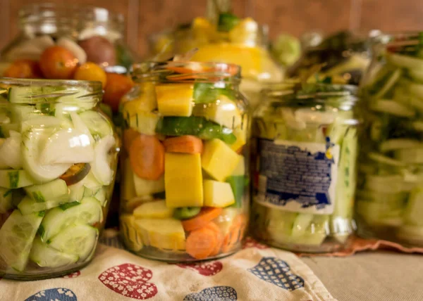 glass jars with various vegetables, canned vegetables, salting various vegetables in glass jars for long-term storage, variety fermented green vegetables