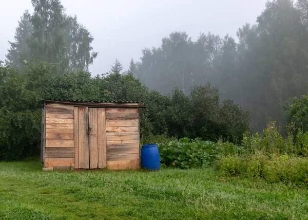 fog landscape, simple wooden garden house, beautiful flowering garden in autumn morning mist, mystical garden