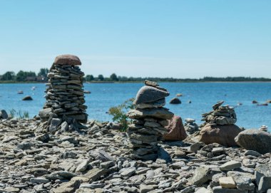 picture with beautiful white stone piles by the sea, these objects were built by travelers, Saaremaa Island, Estonia clipart