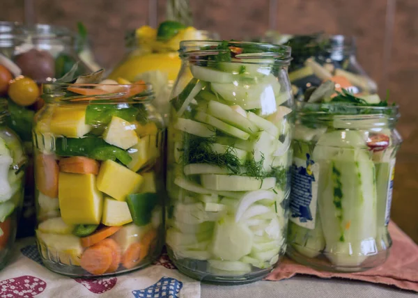 glass jars with various vegetables, canned vegetables, salting various vegetables in glass jars for long-term storage, variety fermented green vegetables