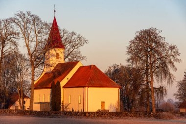 Sabah ışığında küçük kırsal kilisenin muhteşem manzarası, doğada gün doğumu, Rubene Kilisesi, Letonya