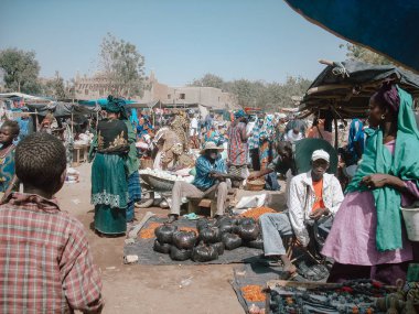 Timbuktu, Mali, Africa - February 3, 2008: People selling and buying at town market clipart