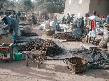 Timbuktu, Mali, Africa - February 3, 2008: People selling and buying fish at town market clipart