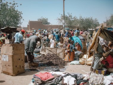 Timbuktu, Mali, Africa - February 3, 2008: People selling and buying at town market clipart