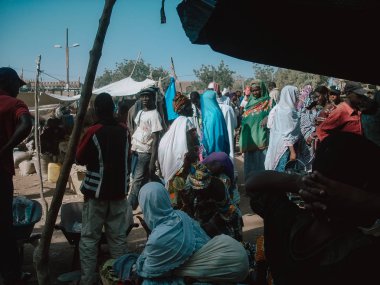 Timbuktu, Mali, Africa - February 3, 2008: People selling and buying at town market clipart