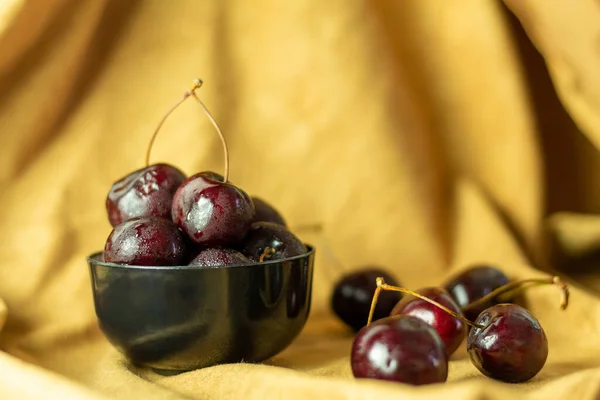 Cherries on a yellow autumn cloth. Concept of healthy food and fruit.