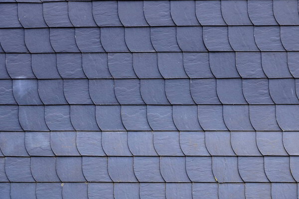 Aged slate roof tiles in close-up