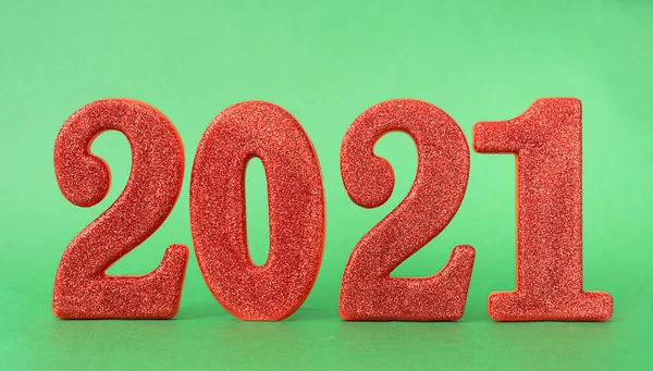 new year concept. red date 2021 New Year on green background.