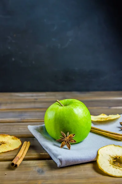 vegetarian apple chips with cinnamon and badyan on a brown background