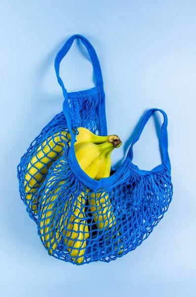 bananas in a blue bag. no plastic.