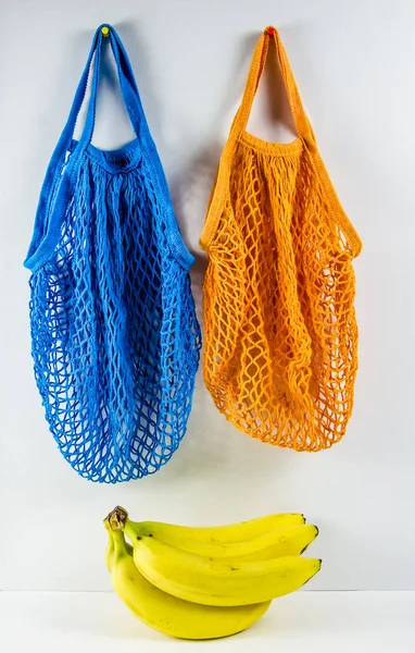 bananas in a blue bag. no plastic.