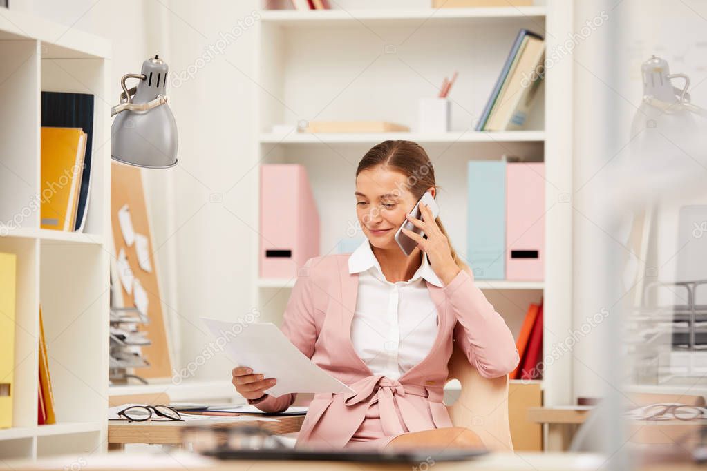 Young businesswoman sitting workplace and concentrating on online work 
