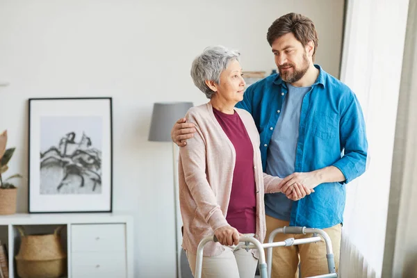 Elderly use walker during rehabilitation for safety — Stock Photo, Image