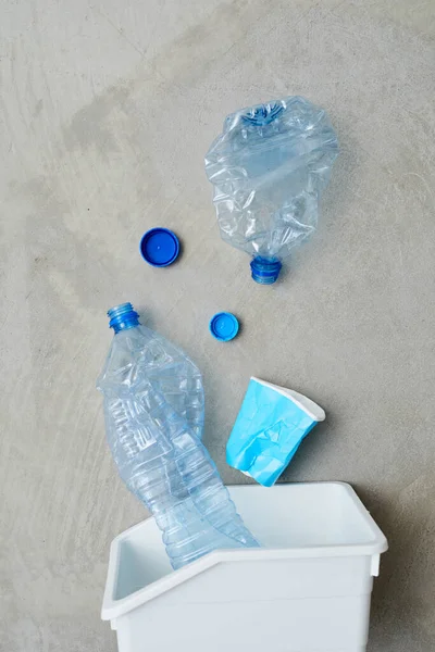 Sorting plastic in trash bin