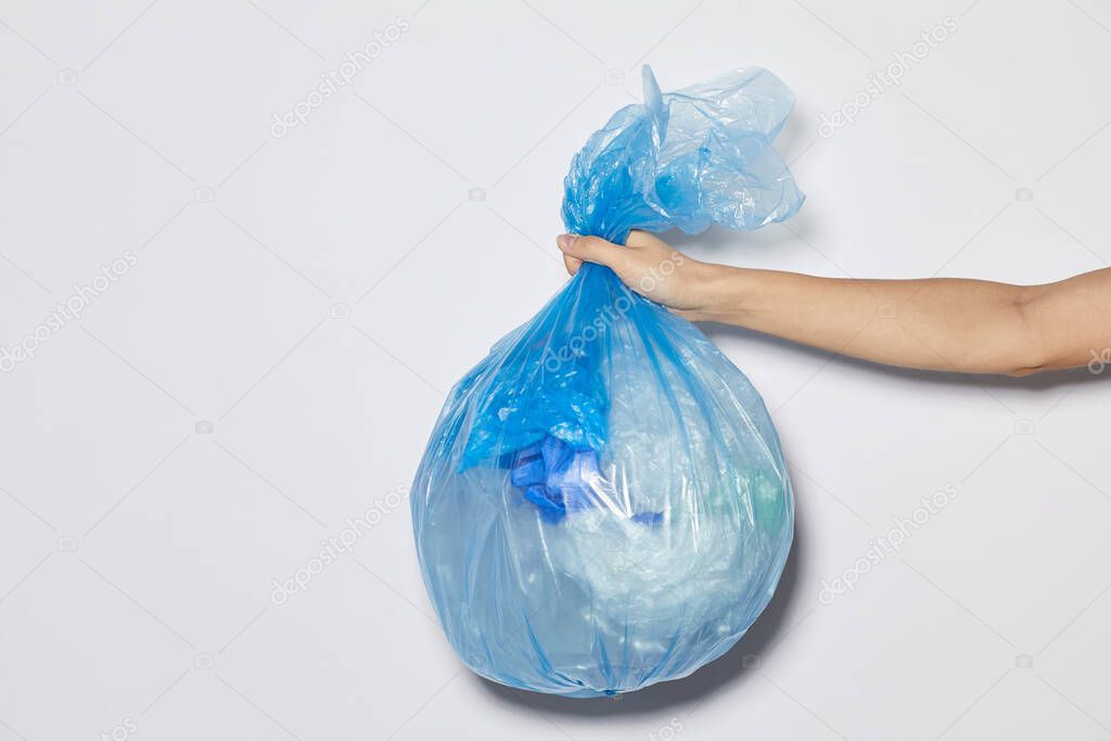 Woman holding garbage bag