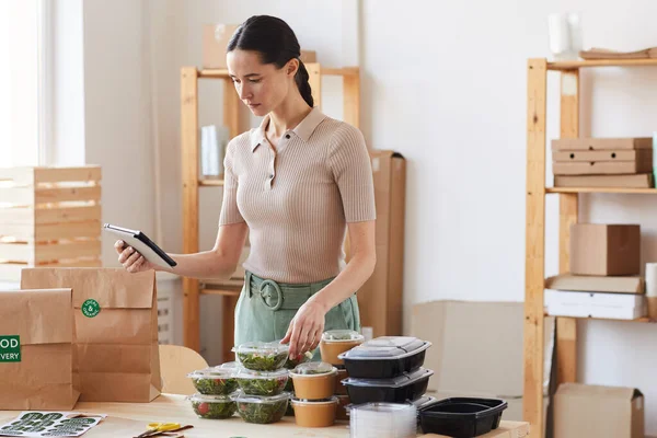 Woman working with online delivery — Stock Photo, Image