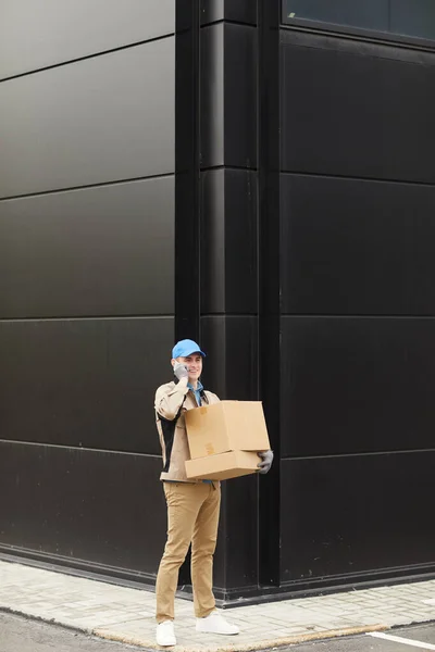 Delivery person carrying boxes