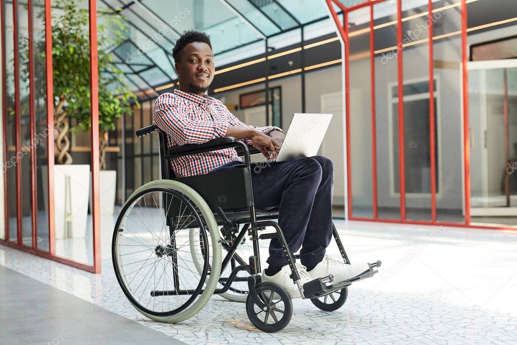 Disabled man working on laptop