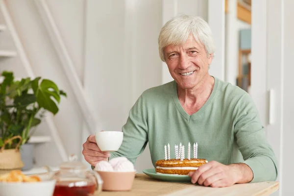 Senior man with cake