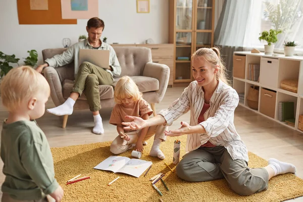 Familia de cuatro personas sentadas en casa — Foto de Stock