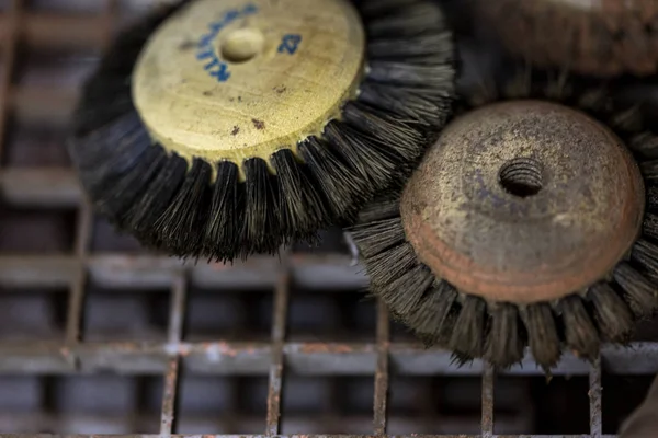 Close up of two polishing brushes that go with a machine used by jewellers to cultivate and polish precious metals such as gold and silver for their jewellery